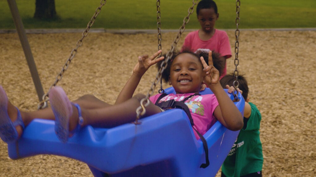 Child playing on swingset