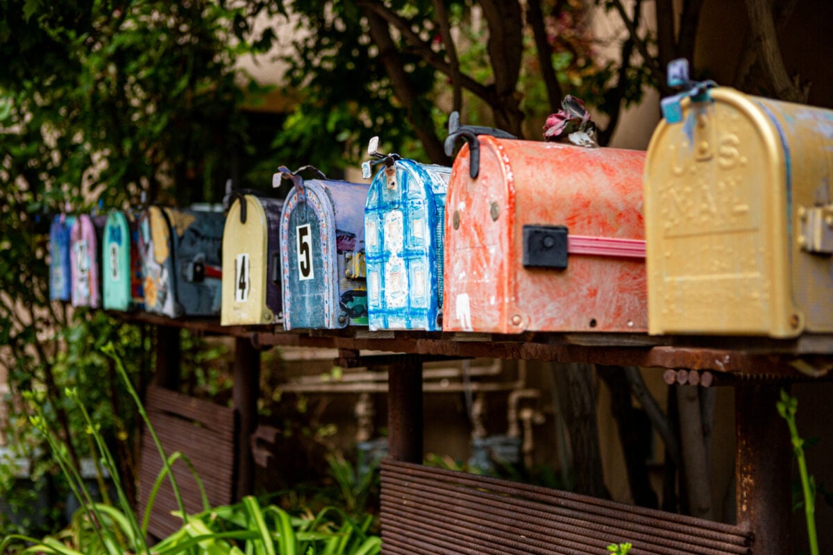 A direct line of colorful mailboxes awaiting mail